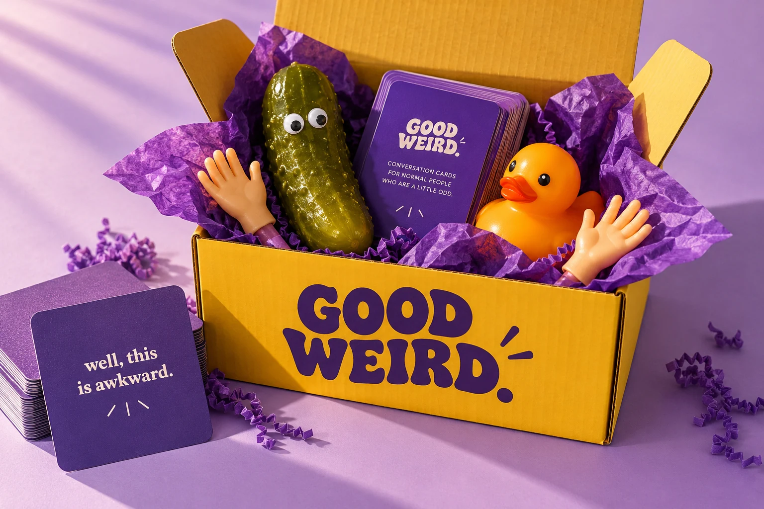 A Good Weird gift box filled with absurd little gifts on lavender